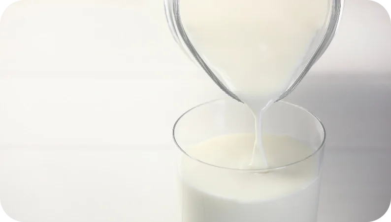 Milk being poured for dairy price analysis